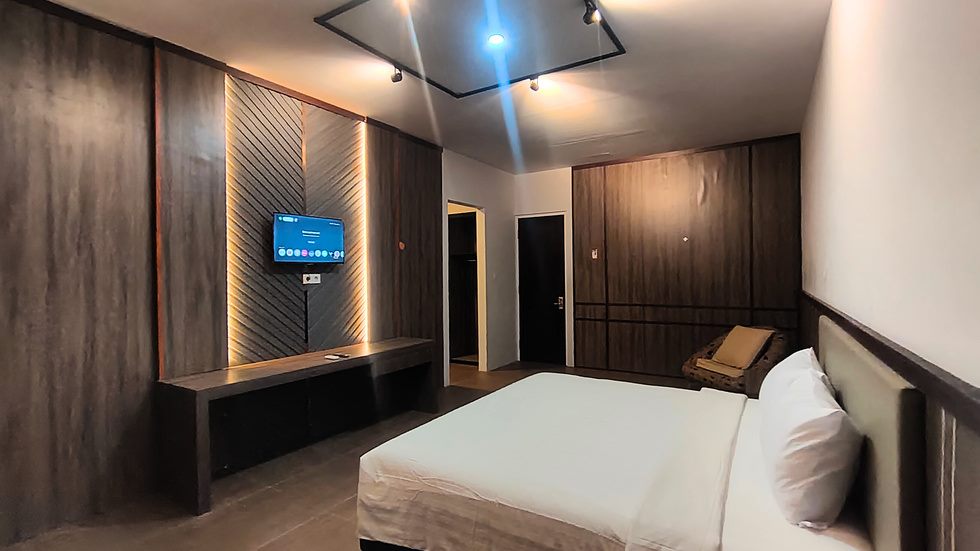 Suite Room Bwalk dengan panel kayu gelap dan smart TV